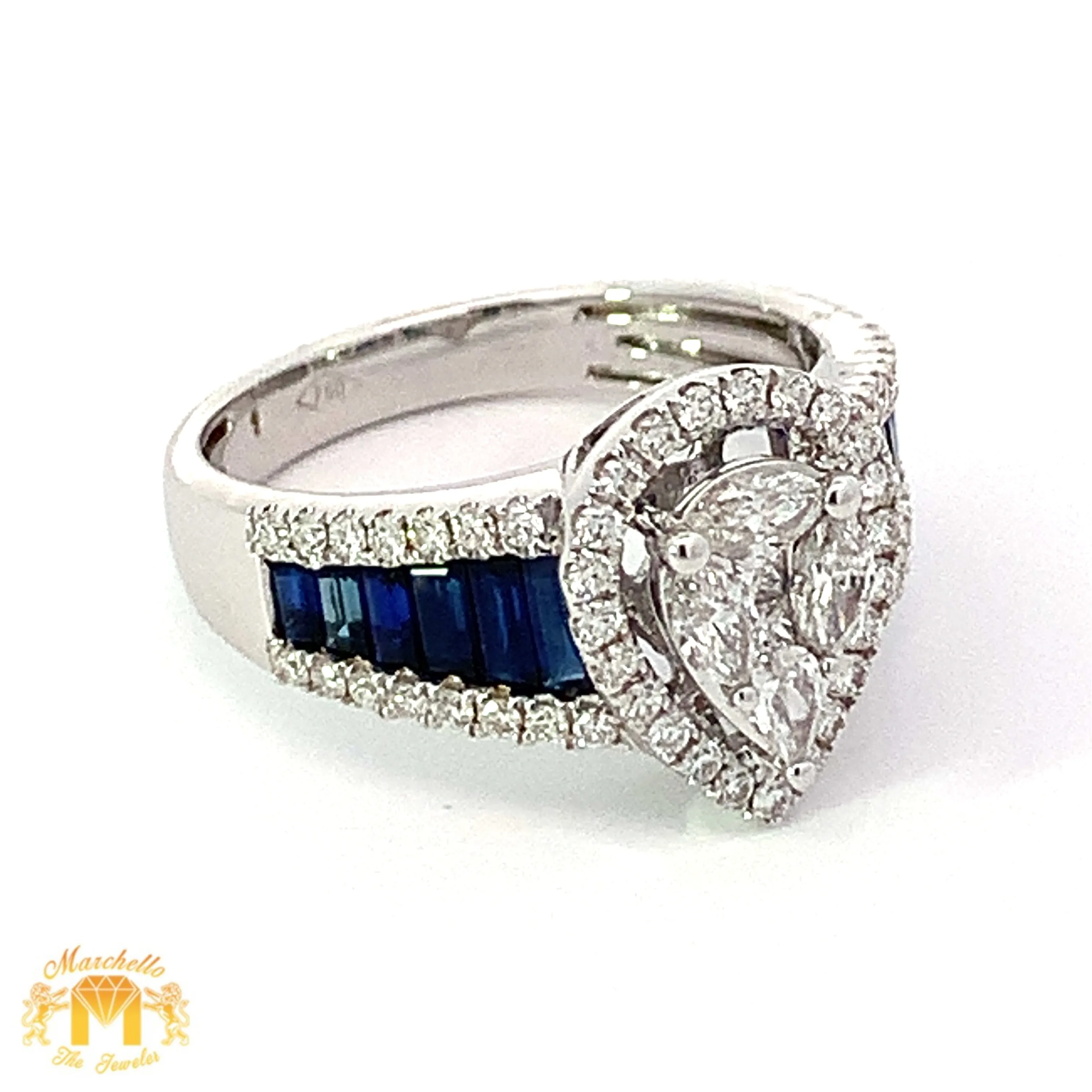 VVS/vs EF color high clarity diamonds set in a 18k Gold Pear Shaped Ring with Blue Sapphire